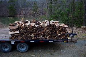 Split and stacked firewood on a flat bed trailer