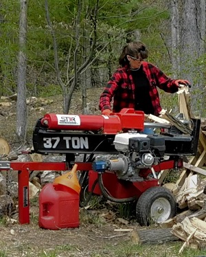 Bren running the wood splitter at Bren Chucks Wood a division of Pioneer Mountain Homestead in James Creek Pennsylvania