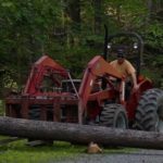 Chuck lifting a log with the Massey Ferguson tractor.
