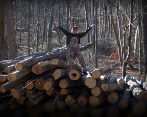 Aunt Bee standing on top of a pile of logs