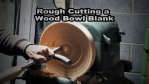 Chuck is turning a bowl blank on the lathe.