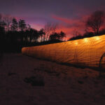 High Tunnel Gardening. Check out the high tunnel as it is lit with solar lights at sunset.